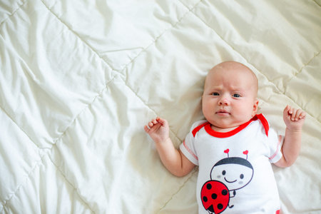 The little baby sleeps folding its legs one on top of the other. Small pink heels of a newborn baby...