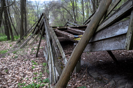 Broken railings of a wooden bridge. Bridge in the middle of the spring forest. Abandoned Old Wooden Structure.の写真素材