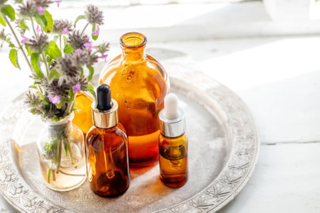 Still life with a bouquet of flowering Clinopodium vulgare, wild basil on an old vintage windowsill with wooden framesの写真素材