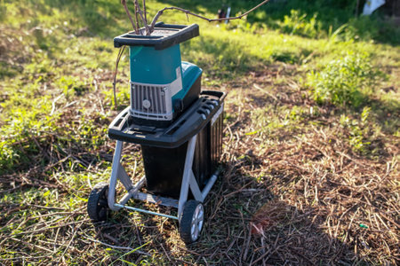 electric garden grinder to shred with a extended filled tank for crushed branches, ready for use in solid fuel boilers, or as mulch for garden workの写真素材