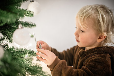 Little boy decorating the Christmas tree. Christmas and New Year conceptの写真素材