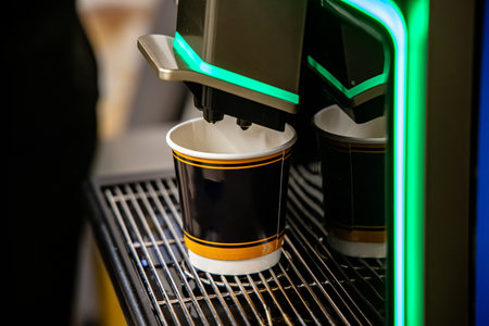 Coffee machine with two paper cups for take away coffee.の写真素材