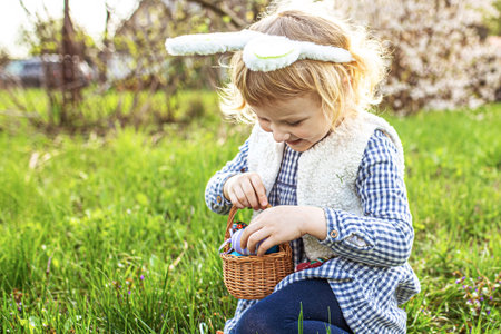 child collected decorated eggs in a basket on Easter day. the holiday and the Easter hunt concept