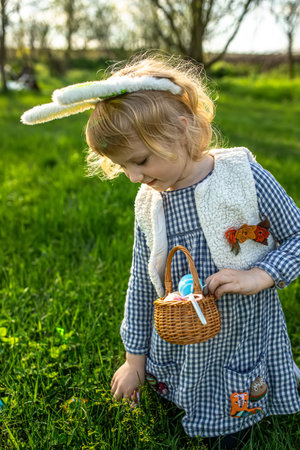 Little adventurer on an Easter quest. child exploring the garden, basket in hand, in search of...