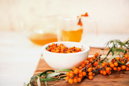 Clear teapot with sea buckthorn tea, a medley of flavors and health benefits. sea buckthorn tea, a...