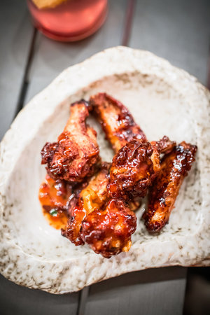 Glazed chicken wings on a plateの写真素材