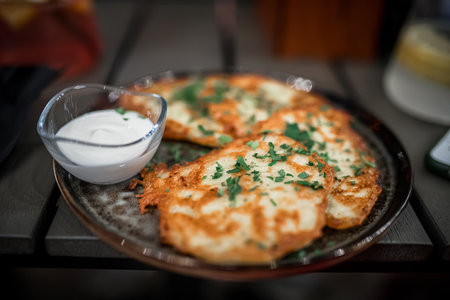 Potato pancakes with sour cream and parsleyの写真素材