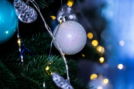 A beautifully decorated Christmas tree adorned with shimmering ornaments and twinkling lights...