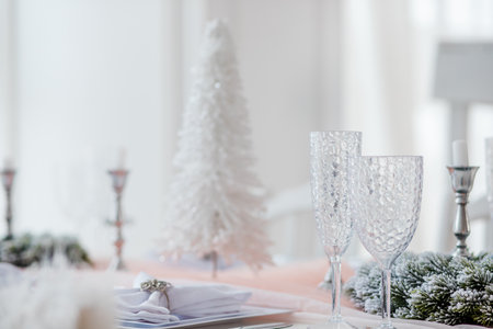Elegant table setup featuring a white decorative tree, ideal for holiday gatheringsの写真素材
