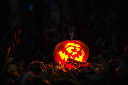 Halloween glowing pumpkin head shining in darkness as festive decor.の写真素材