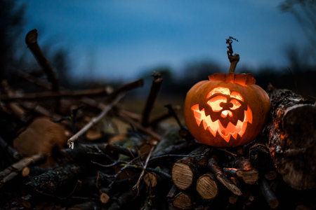 Halloween lantern pumpkin glowing in shadows, perfect for spooky backgrounds.