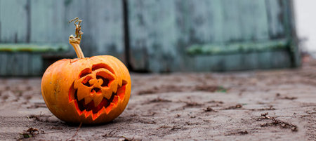 A jack-o-lantern with creepy teeth shining in the misty background.の写真素材
