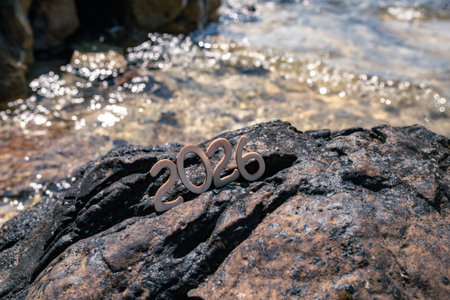 Numbers are positioned on a rock by the water