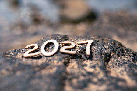 Numbers placed on a rock at the beach in 2027