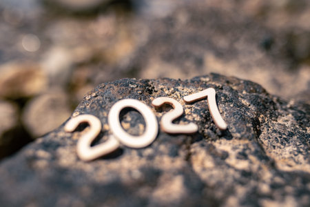 Numbers carved into a rock in 2027 by the sea