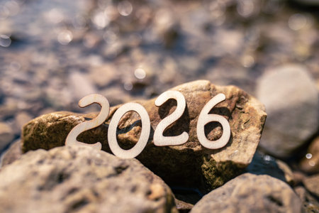 Number 2026 placed on rocks by a riverbank