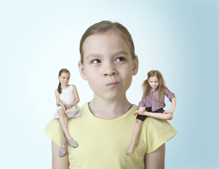 Little girl makes a choice between two of his charactersの写真素材