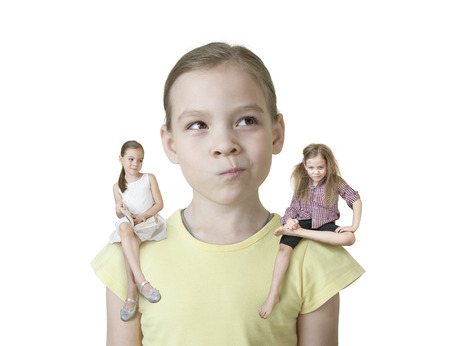 Little girl makes a choice between two of his characters without backgroundの写真素材