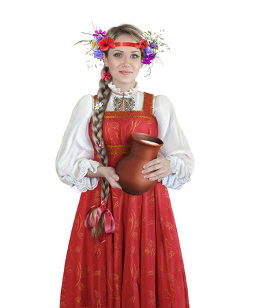 Russian girl in national dress with a jug of milk on a white backgroundの写真素材