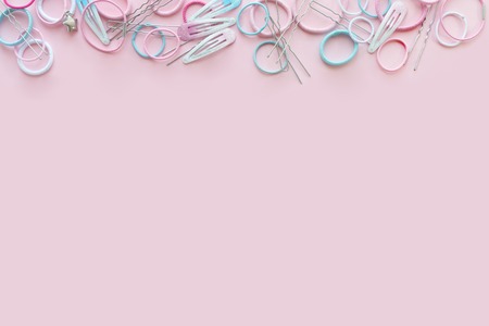 Hair scrunchies and hairpins on pink background, beauty concept, flat layの写真素材