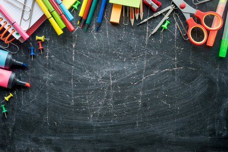Border of School supplies on a chalkboard background. Free spaceの写真素材
