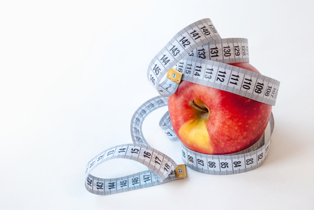 Apple and measuring tape on white background. Diet conceptの写真素材