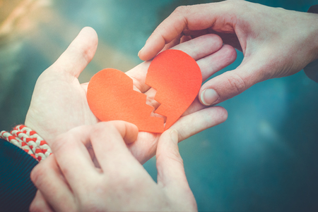 Male and female hands repairing a broken heart. Divorce concept. Love conceptの写真素材
