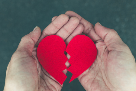 Broken heart in the hands - divorce conceptの写真素材