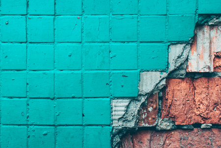 Texture old tile wall. Background of Wall fragment with broken tile and bricksの写真素材
