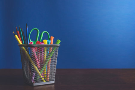 Schoolchild and student studies accessories. Back to school concept. Pencils and felt pens on blue...