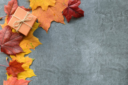 Autumn composition. Maple leaves and gift box. Flat lay, top view