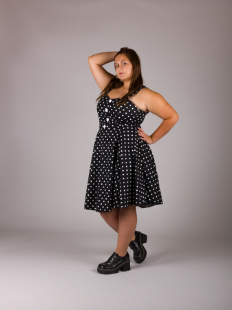 Beautiful Curvy Teenage Girl in Polkadot Dress and Black Shoesの写真素材