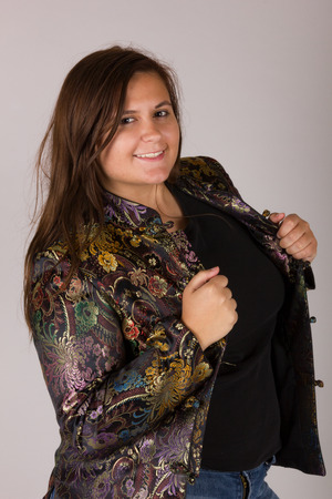 Beautiful Curvy Teenage Girl in Black Shirt Peacock Coat and Jeansの写真素材