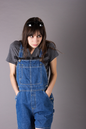 Worried Cute Young Millennial Woman in Overalls Shoes Concern Fear Scared Apprehensiveの写真素材