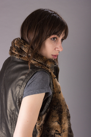 Portrait of a Cute Young Millennial Woman in Furry Vest and Overalls Portraitの写真素材