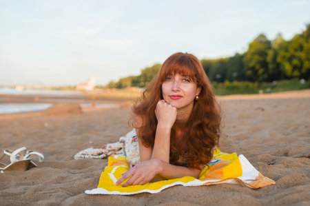 Erotic Girl with red long hair in the summer on quay of river Volga