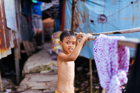 The smile of a child after the cold shower in mekong riverのeditorial素材
