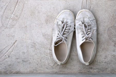 old white sneaker on cement floorの写真素材