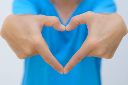 man hand in heart shape reach out forwardの写真素材