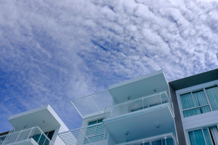 low angle view of low rise modern architecture in blue cloud skyの写真素材