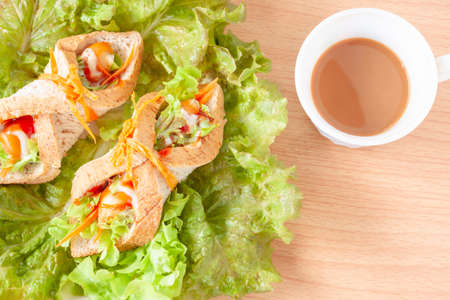 Sandwich whole wheat bread with sausage and coffeeの写真素材