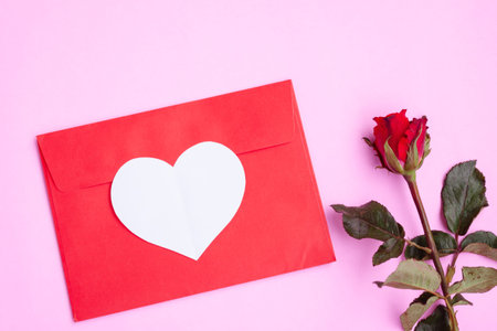 Red envelope with white heart papercut and red rose