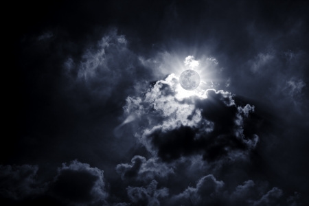 The moon between a lot of cloud.の写真素材