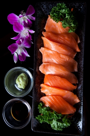 Salmon sashimi served with soy sauce and wasabi.の写真素材