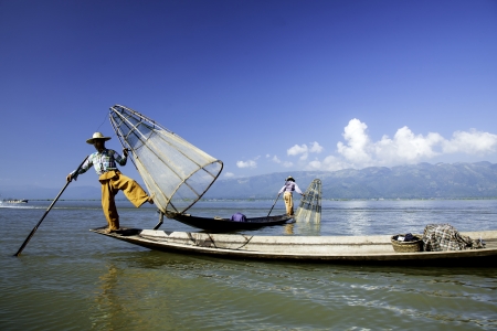 Inle Lake, Myanmar - circa Nov 2013  Burmese man rowing a small boat in Inle Lake  The Inle natives are famous for their unique leg rowing technique の写真素材