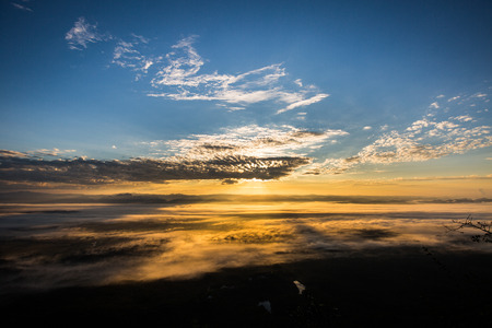 Sunrise beyond the mist in the mountain.の写真素材