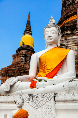 White Buddha image in front of pagoda.の写真素材