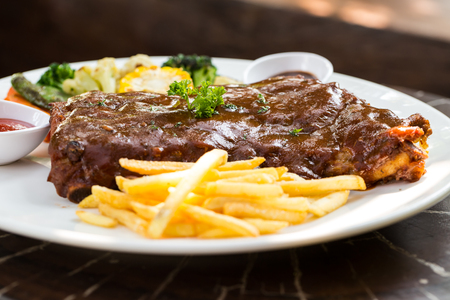 Grilled barbecue pork ribs with sauce and vegetable.の写真素材