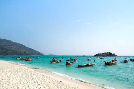 White sand and blue sea and the local boats.の写真素材
