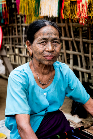 Kyi Chaung, Mrauk U, Rakhine state, Myanmar - Jan 3, 2017: An old Chin woman with tattooed face in Chin village.のeditorial素材